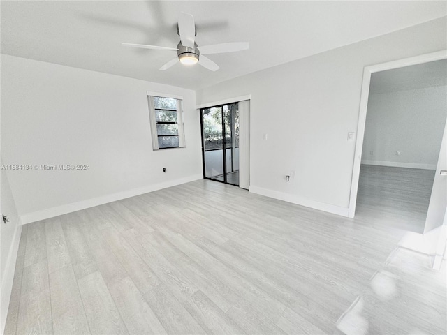 empty room with ceiling fan and light wood-type flooring