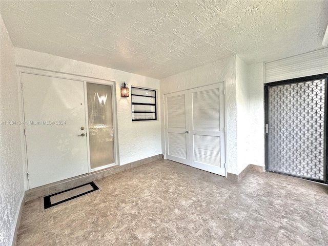 unfurnished bedroom featuring a closet and a textured ceiling