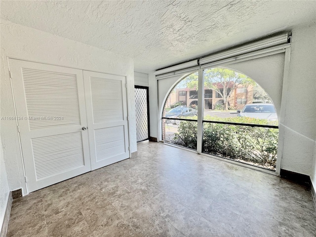 unfurnished bedroom featuring a closet and a textured ceiling