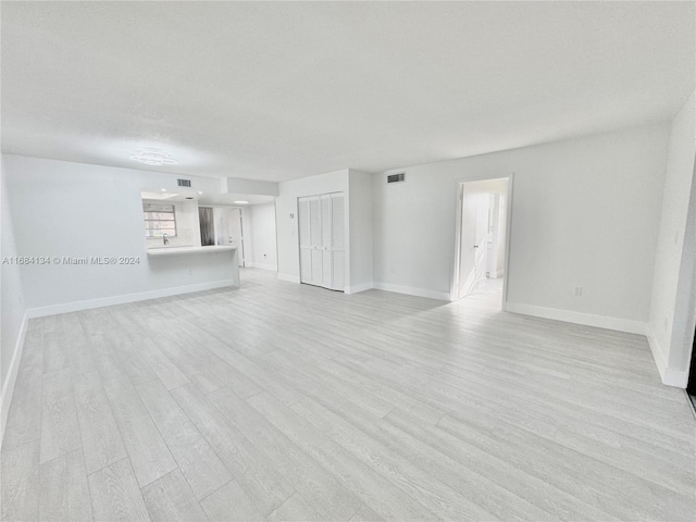 unfurnished living room with light wood-type flooring