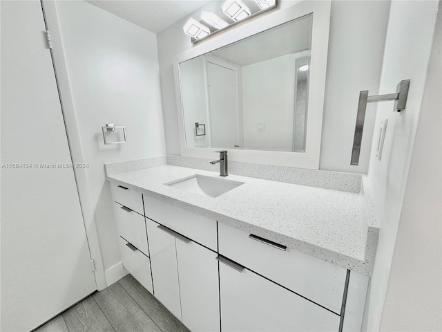 bathroom with vanity and hardwood / wood-style flooring