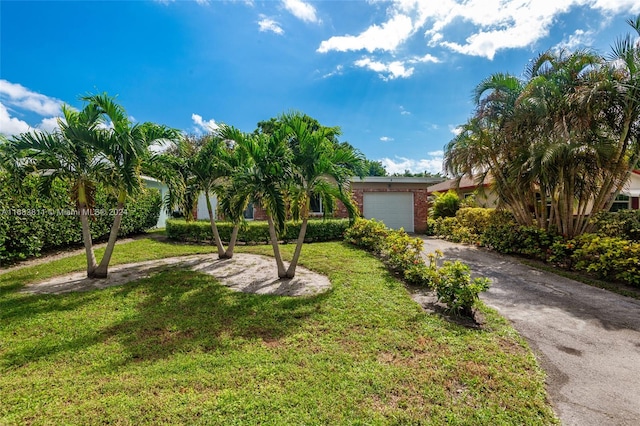 view of front of house with a front lawn and a garage