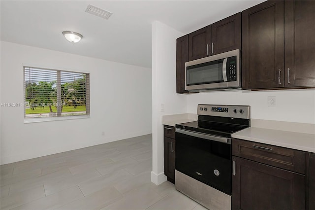 kitchen with appliances with stainless steel finishes and dark brown cabinets