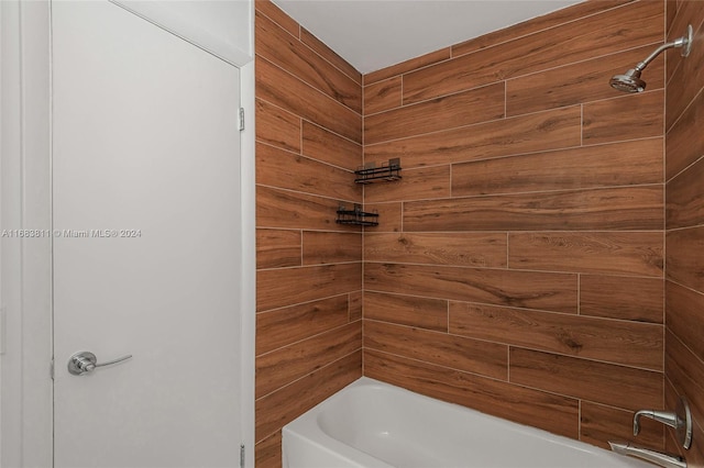 bathroom with wooden walls and shower / tub combination