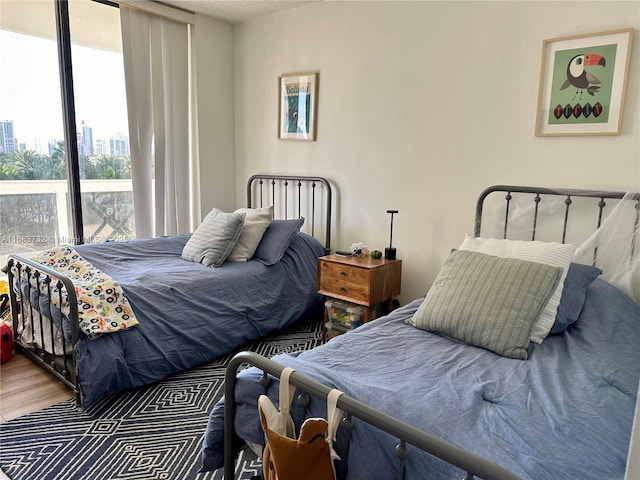 bedroom with a textured ceiling and hardwood / wood-style floors