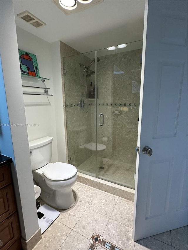 bathroom featuring an enclosed shower, vanity, toilet, and tile patterned floors