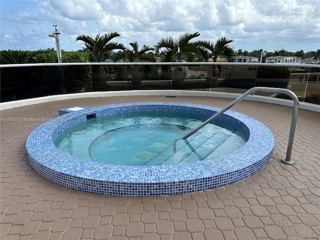 view of swimming pool featuring a community hot tub