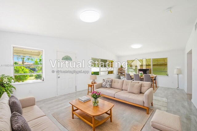 carpeted living room featuring vaulted ceiling