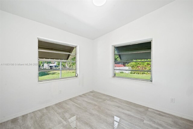 spare room with lofted ceiling