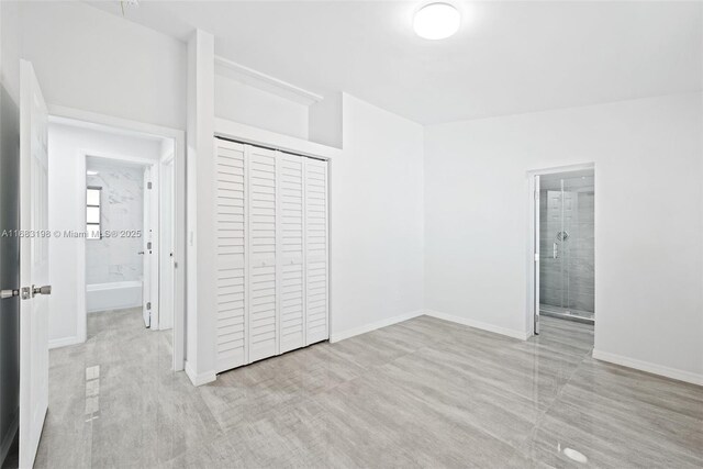 empty room with light hardwood / wood-style floors and lofted ceiling