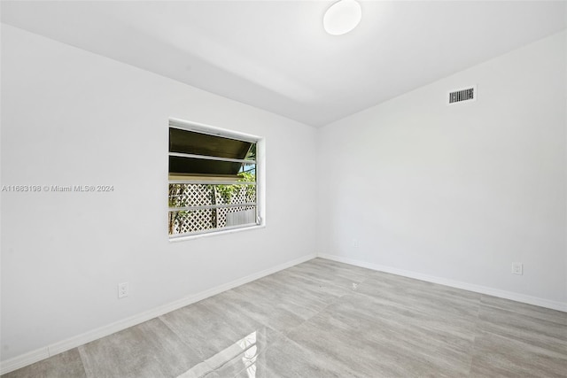 unfurnished room with lofted ceiling