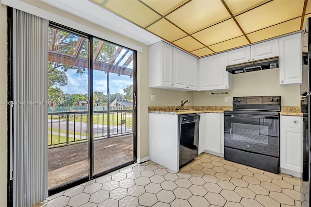 kitchen with white cabinetry, black appliances, and light stone counters