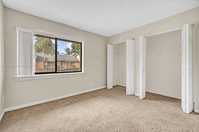 unfurnished bedroom featuring a textured ceiling and carpet flooring