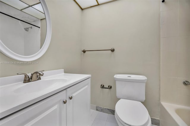 full bathroom featuring toilet, vanity, tiled shower / bath, and tile patterned floors