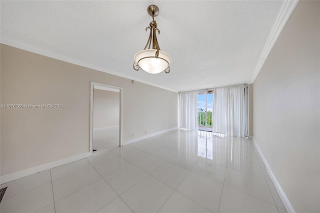 spare room featuring ornamental molding and a textured ceiling