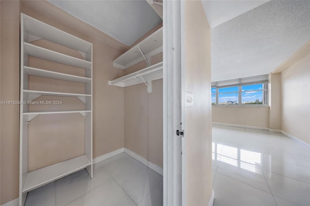 spacious closet featuring light tile patterned floors