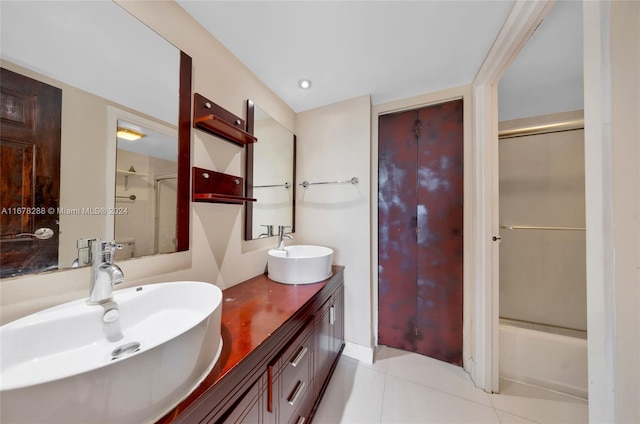 bathroom with vanity, enclosed tub / shower combo, and tile patterned flooring