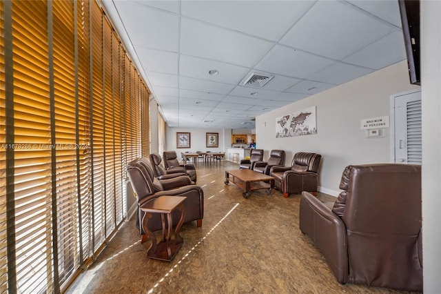 living room featuring a paneled ceiling