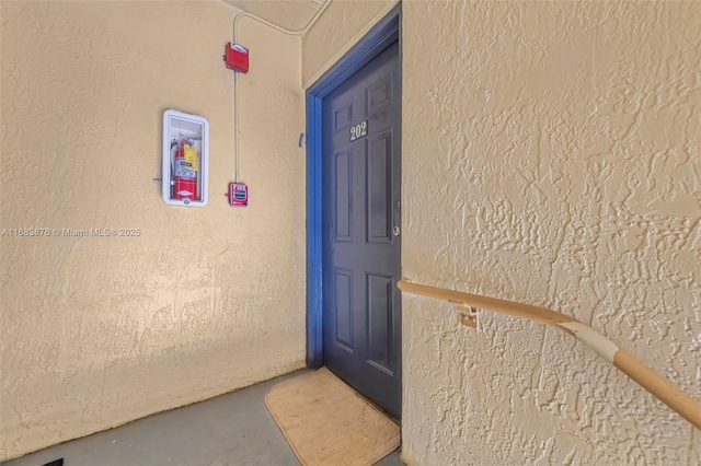 entrance to property with stucco siding