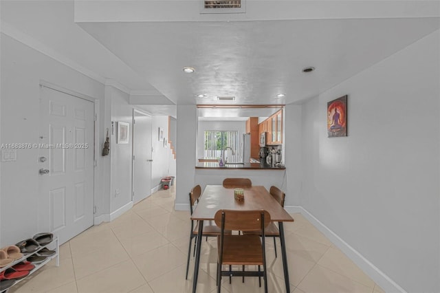 dining area with light tile patterned flooring, baseboards, and recessed lighting