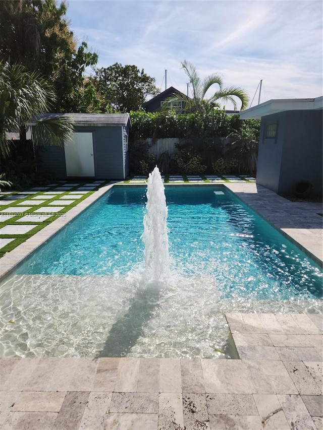 view of pool featuring pool water feature and an outdoor structure