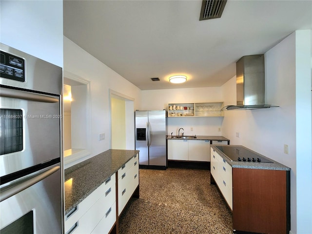 kitchen featuring sink, stainless steel appliances, ventilation hood, dark stone countertops, and white cabinets