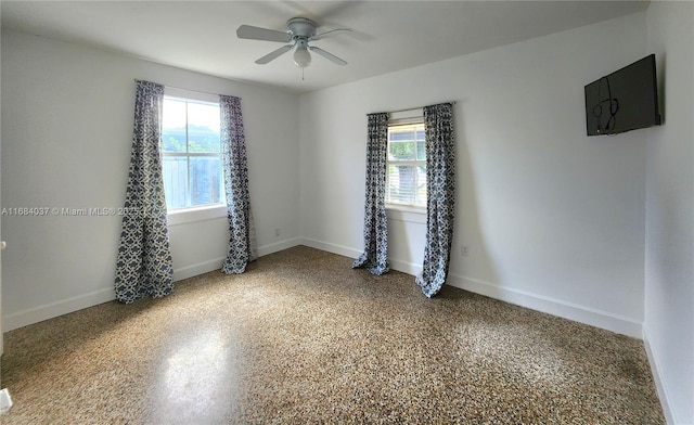 unfurnished room with a wealth of natural light and ceiling fan