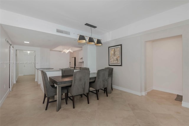 tiled dining room featuring a chandelier