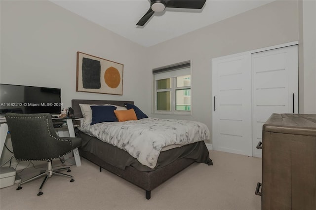 bedroom featuring a closet, ceiling fan, and light carpet