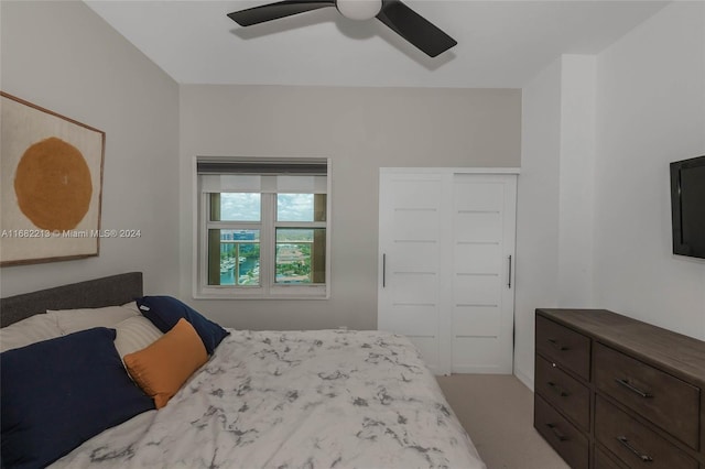 bedroom with light carpet, a closet, and ceiling fan