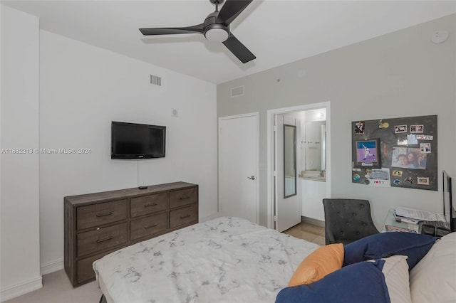 bedroom featuring light colored carpet, connected bathroom, and ceiling fan