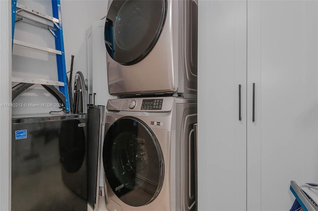 clothes washing area with stacked washer and dryer