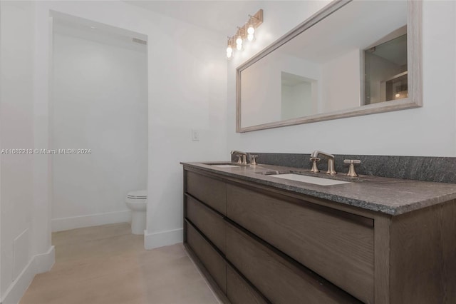 bathroom featuring toilet and vanity