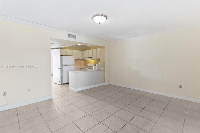 unfurnished living room with crown molding and light tile patterned floors