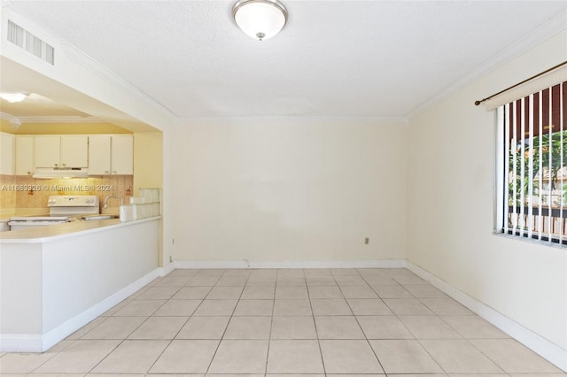 unfurnished room featuring ornamental molding, sink, and light tile patterned flooring