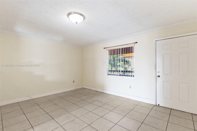 spare room featuring crown molding, a textured ceiling, and light tile patterned floors