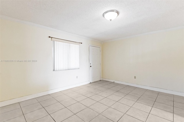 empty room featuring ornamental molding, light tile patterned flooring, and a textured ceiling