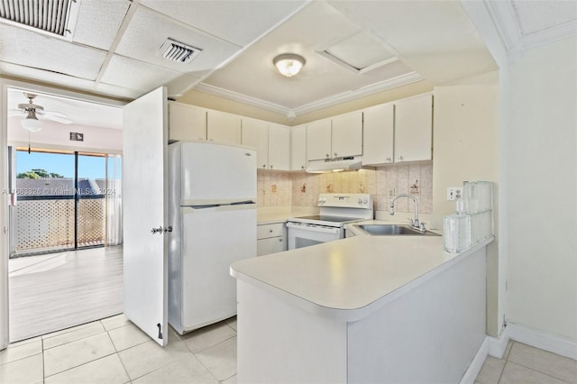 kitchen featuring kitchen peninsula, decorative backsplash, sink, and white appliances