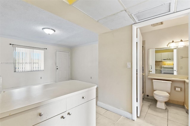 interior space with toilet, vanity, and tile patterned flooring