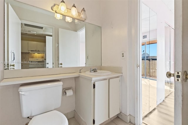 bathroom featuring vanity, hardwood / wood-style floors, and toilet