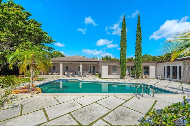 view of pool featuring a patio and french doors