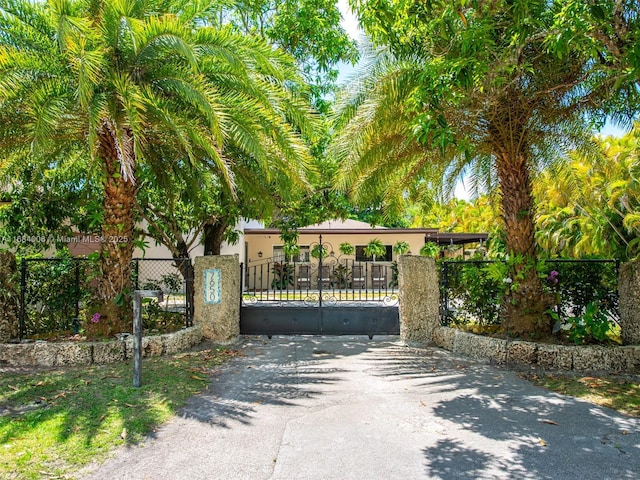 view of gate with a fenced front yard