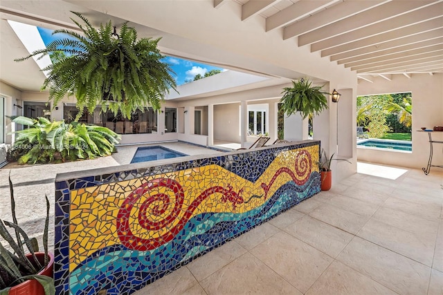 view of swimming pool featuring an in ground hot tub and a patio