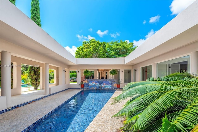 view of swimming pool featuring a patio area