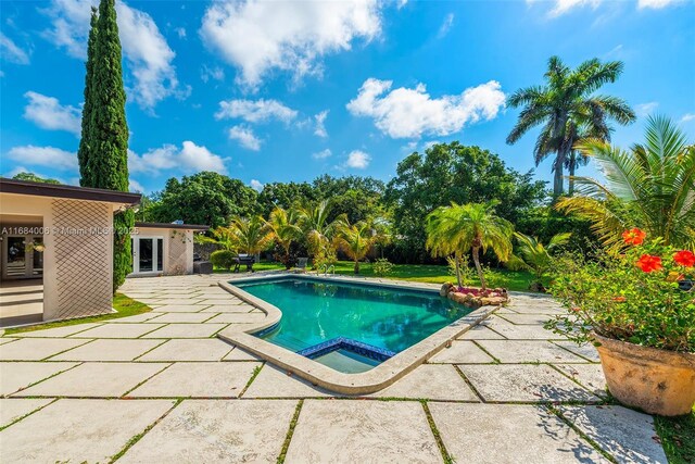 view of swimming pool with a patio area and an outdoor structure