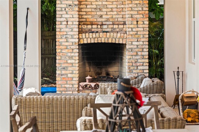 view of patio / terrace featuring an outdoor brick fireplace and ceiling fan