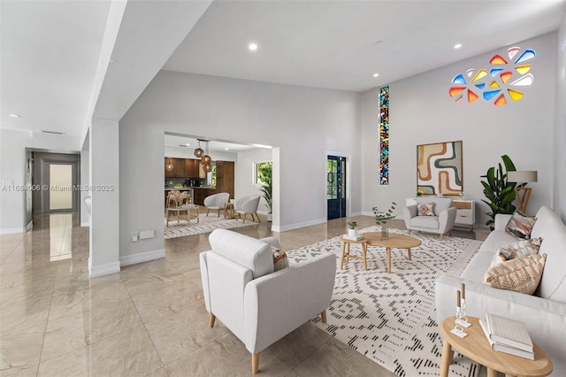 living room featuring a towering ceiling