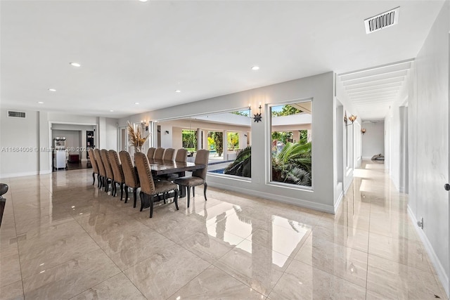 dining room with baseboards, visible vents, and marble finish floor