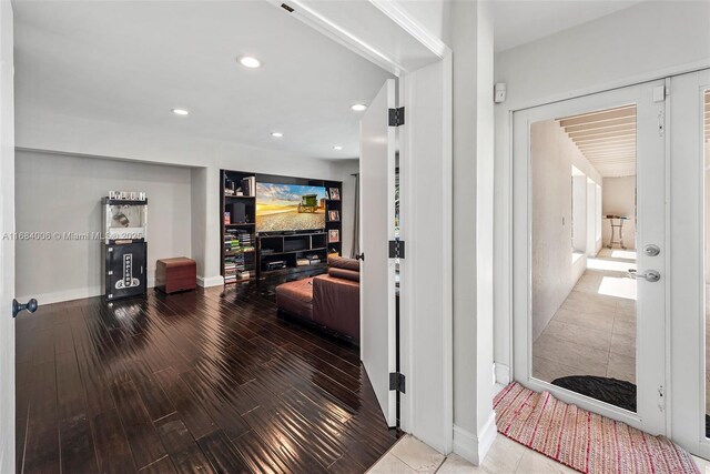 hallway featuring recessed lighting, baseboards, and wood finished floors