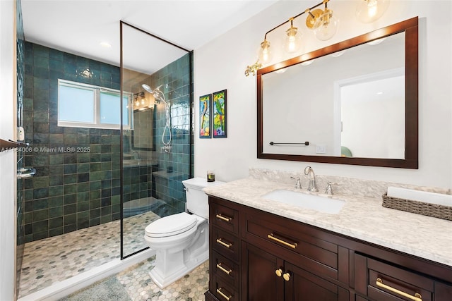 bathroom with toilet, tile patterned floors, tiled shower, and vanity